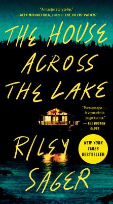 Book cover for “The House Across the Lake” by Riley Sager, depicting a brightly lit house reflected in dark lake water at night, with handwritten-style yellow title text.