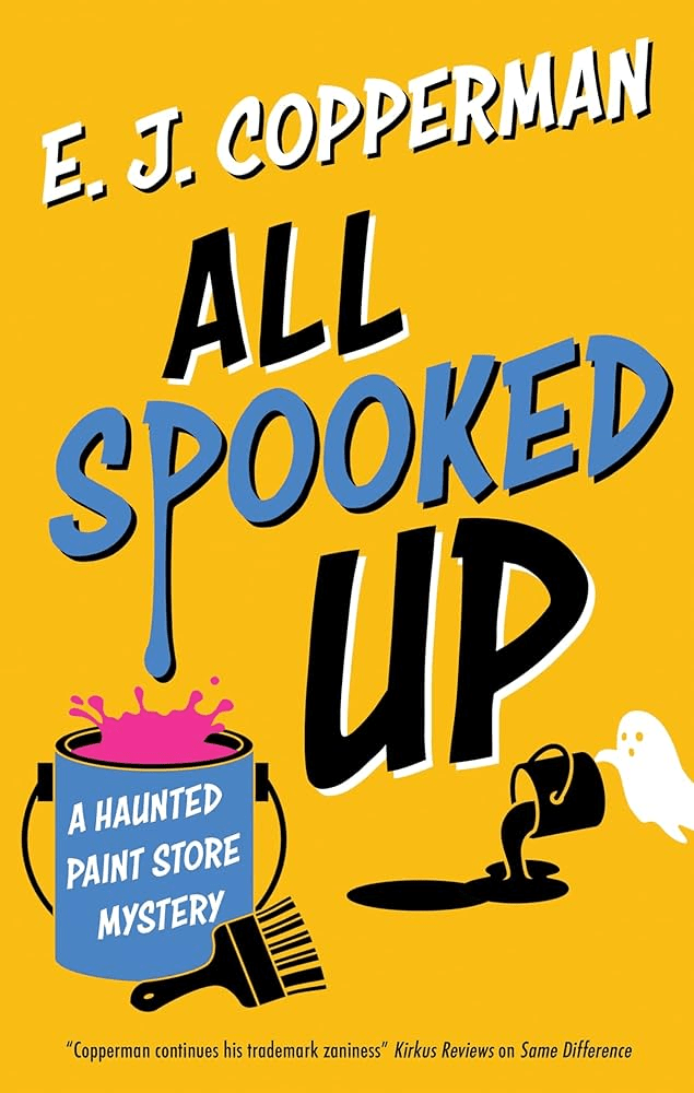 Book cover for All Spooked Up by E. J. Copperman. The background is bright yellow with playful, cartoon-style graphics. The title appears in bold black and blue lettering, with blue paint dripping from the word “Spooked.” Illustrations include a tipped-over black paint can spilling paint, a small white ghost, and a blue paint bucket labeled “A Haunted Paint Store Mystery” with pink paint splashing out. The overall tone is lighthearted and humorous.